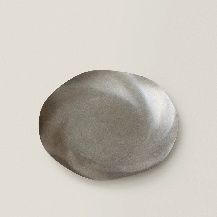 Round metallic object on a beige background