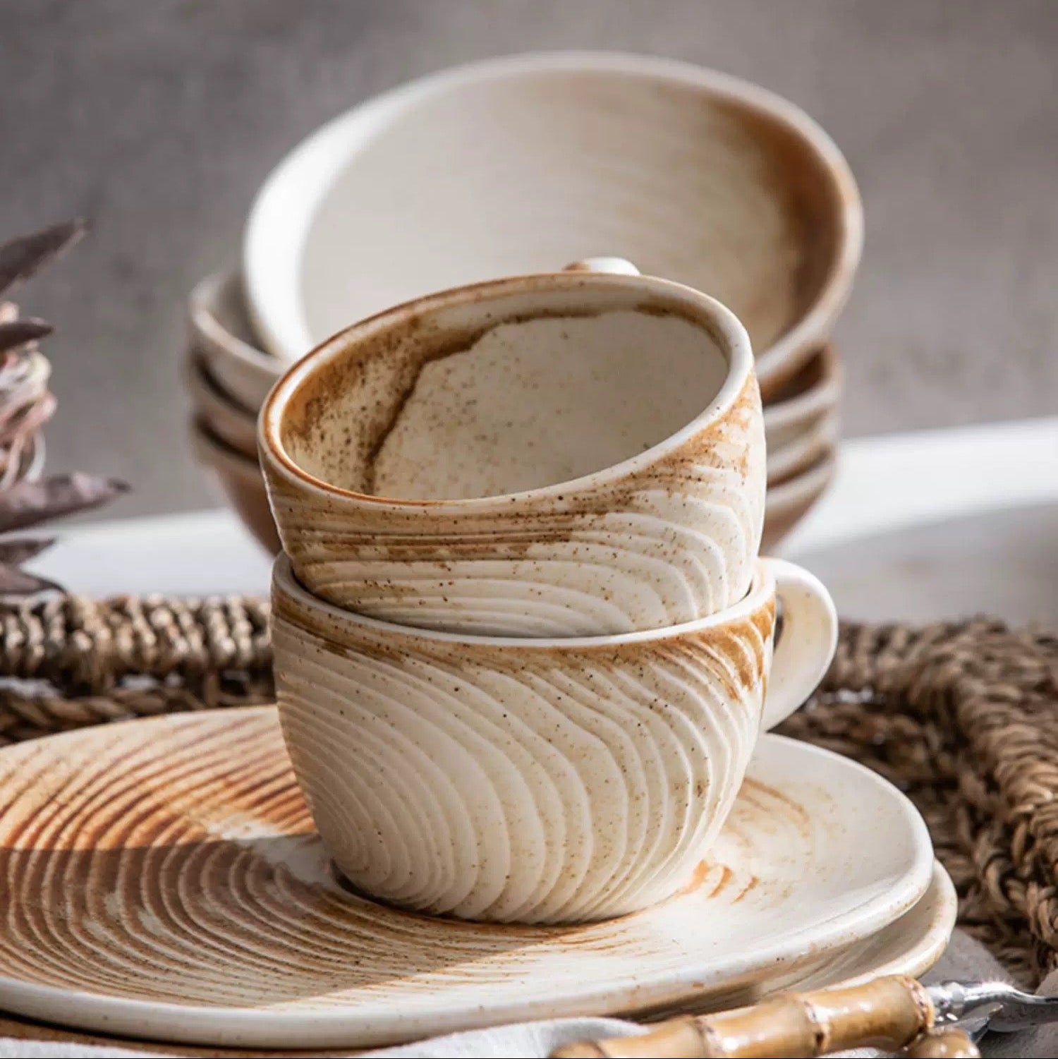 Coffee cup and saucer set with text on a neutral background